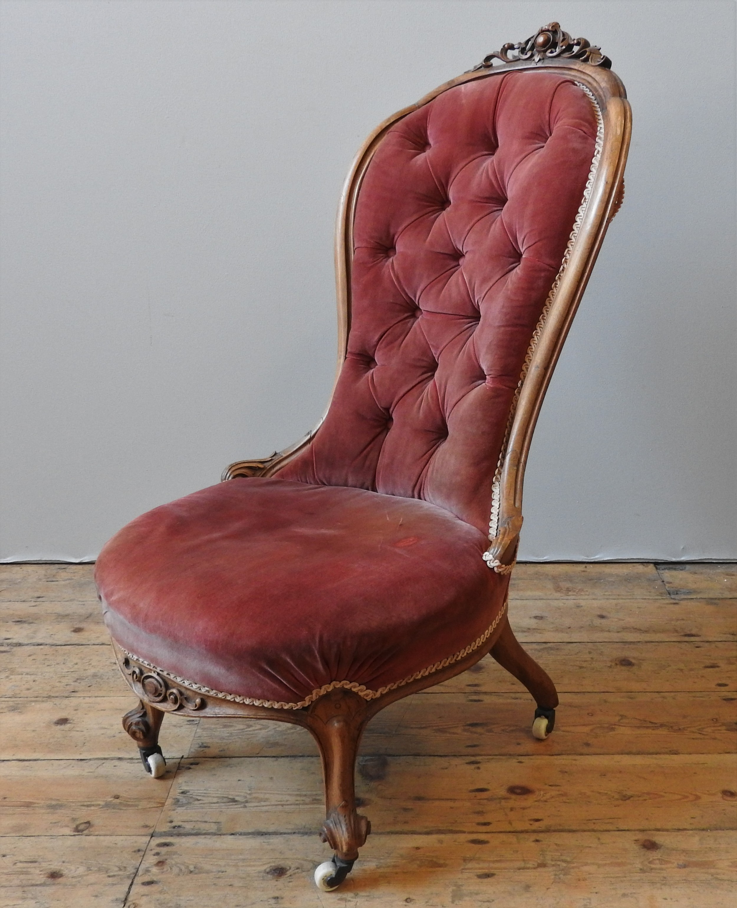 A 19TH CENTURY WALNUT NURSING CHAIR,  the walnut frame with scroll cartouche detail to the top,