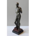 A BRONZE STATUE OF ANATOMICAL NUDE, in the manner of Jean Antoine Houdon, the figure resting against