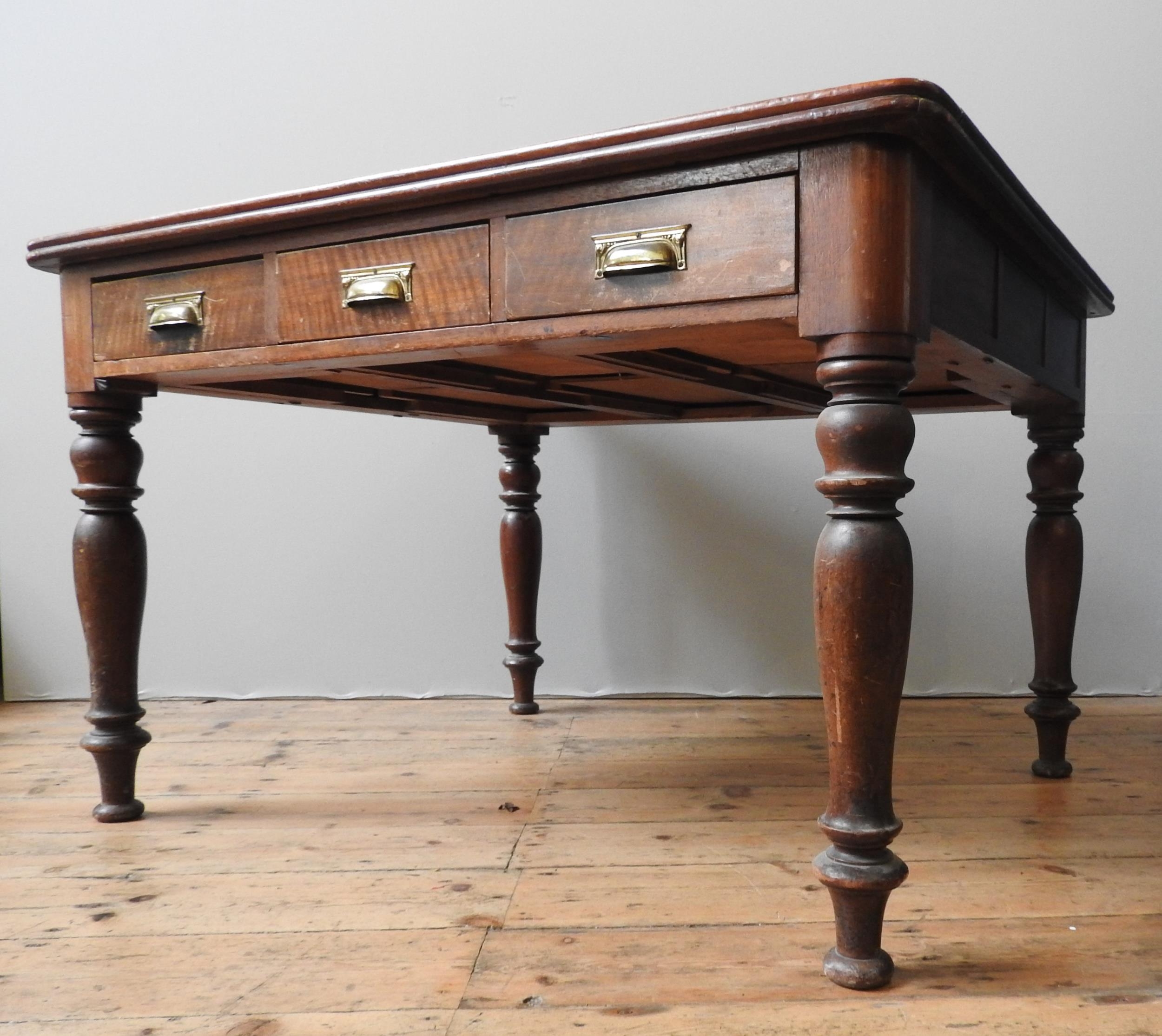 A 19TH CENTURY MAHOGANY LIBRARY TABLE, with three short frieze drawers on four turned baluster legs,