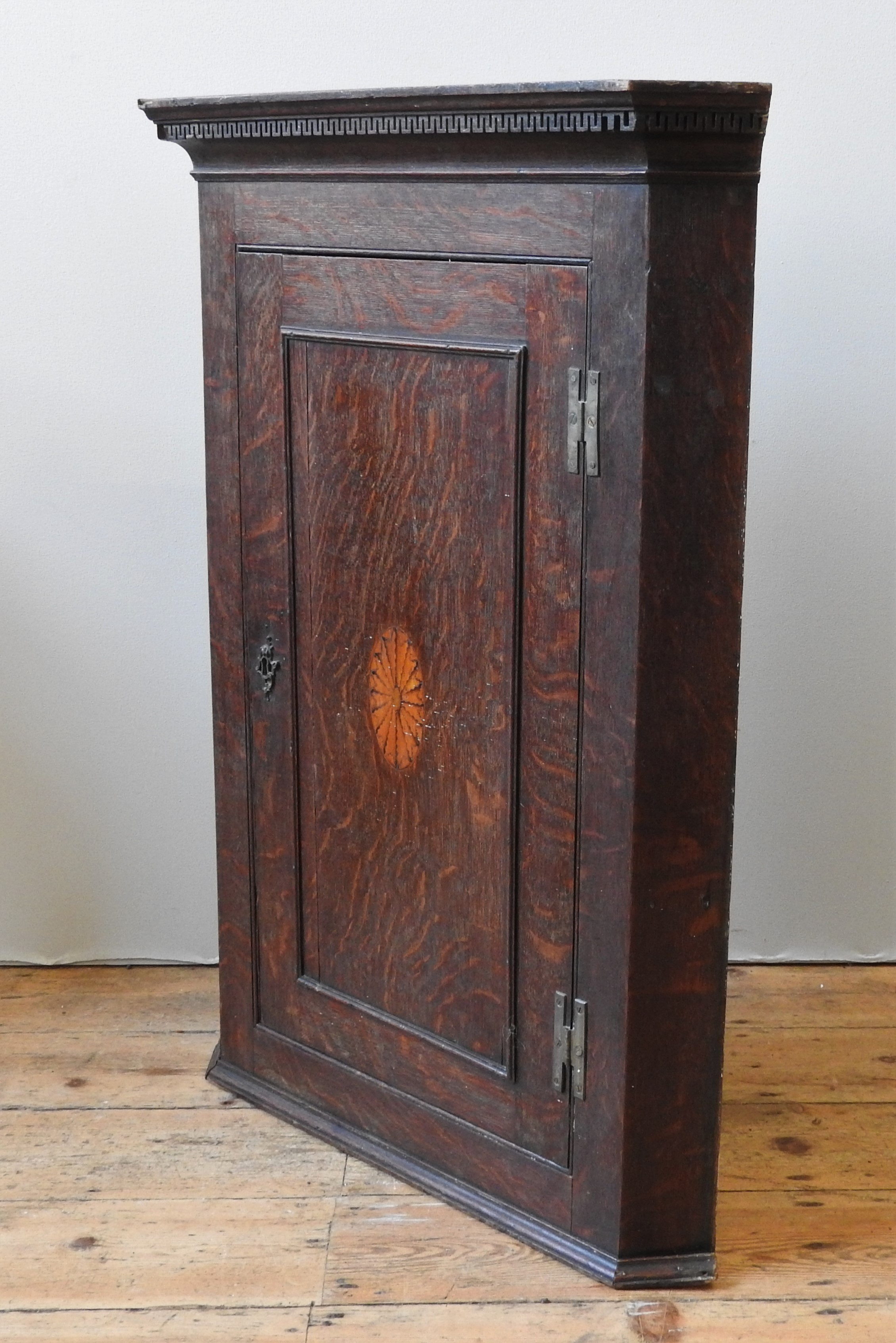 A 19TH CENTURY OAK CORNER CUPBOARD, wall hanging, Greek key decorated cornice above a single door