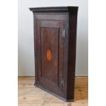 A 19TH CENTURY OAK CORNER CUPBOARD, wall hanging, Greek key decorated cornice above a single door