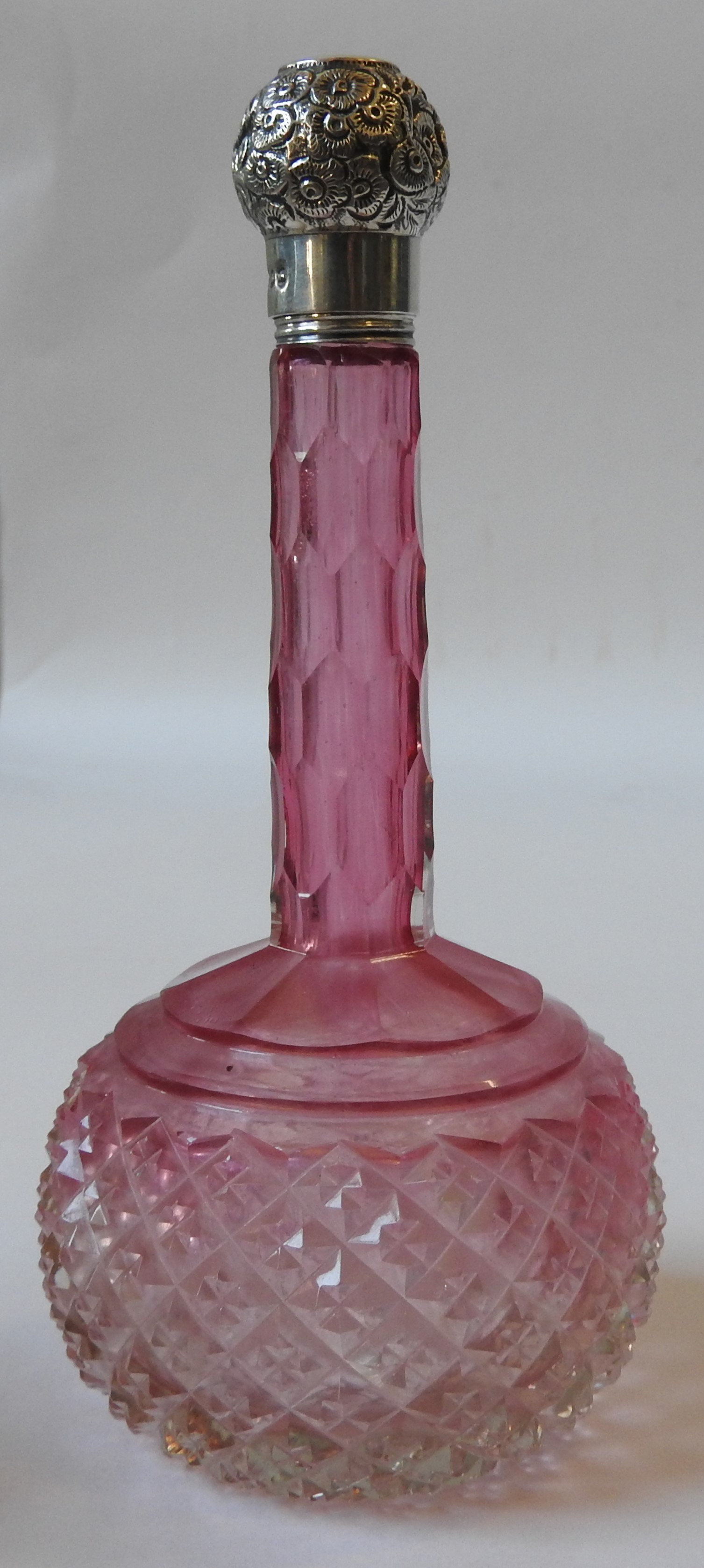 A 19TH CENTURY CRANBERRY GLASS BOTTLE, hobnail cut globular body with a slender faceted neck, with a