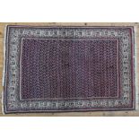 A PERSIAN RUG, dark blue ground, central panel with Boteh decoration 124 x 94 cm