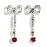 A PAIR OF EDWARDIAN RUBY AND DIAMOND EARRINGS the diamond set bow suspending an articulated bar drop