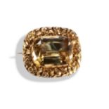 A VICTORIAN CITRINE BROOCH a rectangular cut citrine set in a border of embossed yellow metal with a