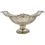 A SILVER FRUIT BOWL, oval form with alternating pierced panel sides with scroll foliate edges and