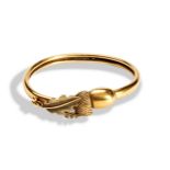 A 19TH CENTURY BICOLOUR GOLD BANGLE with acorn and leaf motif, acorn slides open. Kite mark Oct,