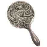 A CHINESE SILVER HAND MIRROR, late 19th Century, depicting a dragon amongst clouds 25cm long, 437