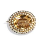 A VICTORIAN CITRINE AND SEED PEARL BROOCH, CIRCA 1870 an oval cut citrine within two stepped borders