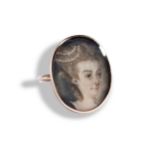 A GEORGIAN PORTRAIT MINIATURE RING, CIRCA 1880 depicting a lady, her hair dressed with pearls.