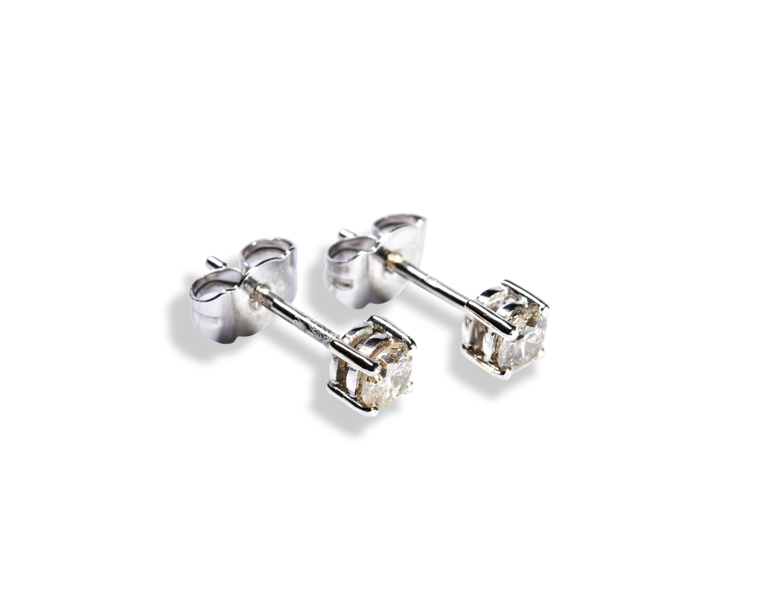A PAIR OF DIAMOND STUD EARRINGS each brilliant-cut diamond four claw set on a white gold post and