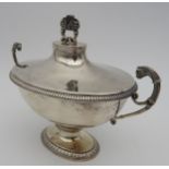 A 19TH CENTURY FRENCH SILVER SAUCE TUREEN AND COVER, ovoid form with gadrooned banding, twin leopard