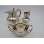 A SILVER CREAM JUG, SUGAR BOWL AND HOT WATER JUG, each bearing the following marks. Cream jug: