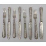 FOUR VICTORIAN SILVER FISH KNIVES WITH FOUR MATCHING FORKS, scroll repousse handles and engraved