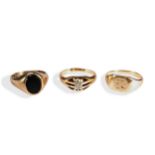 A COLLECTION OF THREE SIGNET RINGS an onyx set signet ring with bezel set, oval flat cut, onyx.