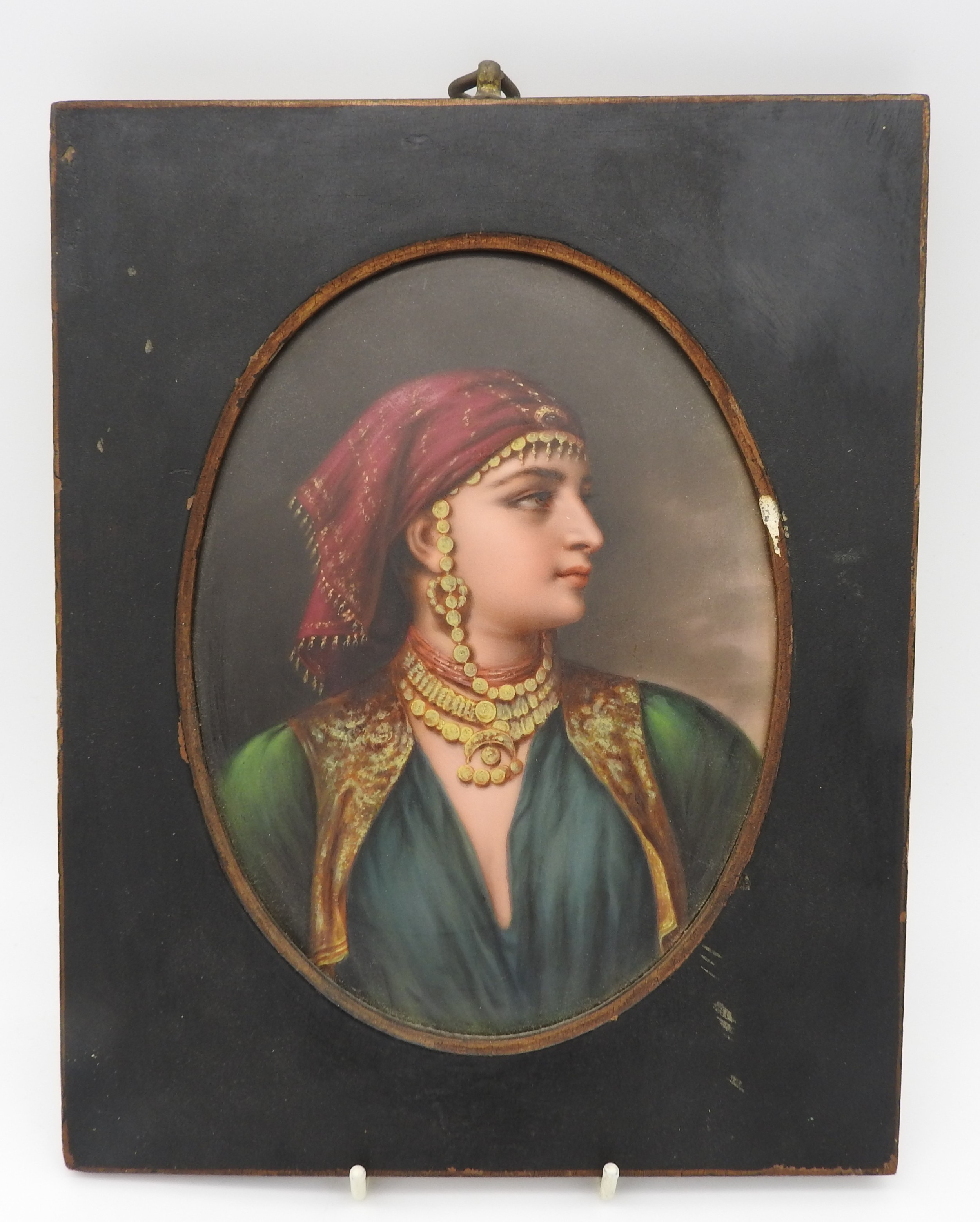 A CONTINENTAL PAINTED OVAL PORCELAIN PLAQUE, LATE 19TH CENTURY, depicting portrait bust of gypsy