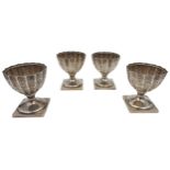 A SET OF FOUR SILVER SALTS, tapered fluted form with chased ribbon tied swag decoration, raised on a