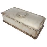 A SILVER CASKET BOX WITH COIN DECORATED LID, oblong form with crimped edges, the lid inset with