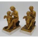 A PAIR OF FRENCH NEO-CLASSICAL STYLE GILT AND PATINATED BRONZE BOOK ENDS, 19th Century, modelled