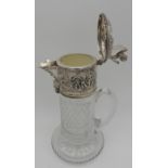 A SILVER MOUNTED CUT GLASS CLARET JUG, 20TH CENTURY, repousse decorated collar and lid depicting a