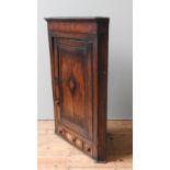 A 19TH MAHOGANY & ELM CORNER CUPBOARD, panelled door enclosing two shelves above a frieze drawer and
