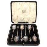 A SET OF SIX SILVER ARTS & CRAFTS TEA SPOONS, in presentation case, elegant scroll arch handles,