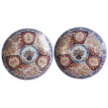 A PAIR OF IMARI CHARGERS, LATE 19TH CENTURY, central roundel with a vase motif, bordered by shaped