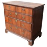 A GEORGE I CROSSBANDED WALNUT CHEST OF DRAWERS, CIRCA 1720, comprised of two short drawers over