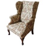 A MAHOGANY FRAMED WING BACK ARMCHAIR, 19TH CENTURY, French style floral tapestry covering, raised on