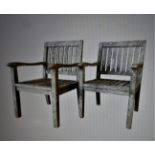A PAIR OF HARDWOOD GARDEN CHAIRS