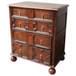 A CHARLES II GEOMETRIC OAK CHEST OF DRAWERS, CIRCA 1680, comprised of four graduated mitre moulded