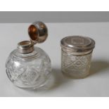 A CUT GLASS SILVER TOP SCENT BOTTLE AND CUT GLASS POT WITH SILVER COVER, CIRCA 1910, globular form