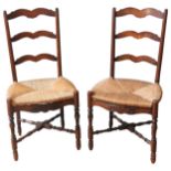 A PAIR OF RUSH SEAT LADDERBACK CHAIRS, 19TH CENTURY, raised on turned baluster legs united by turned