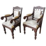 A PAIR OF OF ANGLO-BURMESE ARMCHAIRS, 19TH CENTURY, profusely carved throughout with scroll