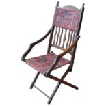 A LATE VICTORIAN FOLDING CARPET CHAIR, CIRCA 1880, with serpentine slatted back panel,  154 x 51 x