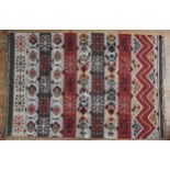 A HAND KNOTTED KHELIM RUG, 20TH CENTURY, alternating vertical bands emblazoned with geometric motifs