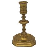 A GEORGE I BRASS CANDLE STICK, EARLY 18TH CENTURY, knopped stem on a square base with canted corners