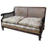 A VINTAGE BERGERE SETTEE, CIRCA 1920  cane panelled mahogany frame with elegant scroll arms,