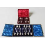 A CASED SET OF SILVER APOSTLE SPOONS AND A NEAR SET OF TEA SPOONS, both in presentation cases, the