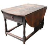 AN 18TH CENTURY OAK GATE-LEG TABLE, wide proportions, oval shaped plank top above end frieze