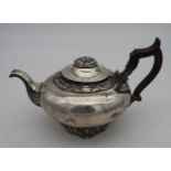 A GERMAN SILVER TEA POT, CIRCA 1860, compressed globular form with scroll spout and wooden scroll