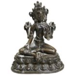 A BRONZE FIGURE OF GREEN TARA TIBET, 15TH / 16TH CENTURY seated in lalitasana on a double-lotus