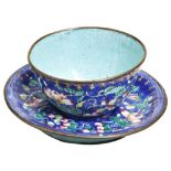 A CANTON ENAMEL CUP AND SAUCER QING DYNASTY, 18TH CENTURY  painted with flower sprays on a rich-blue