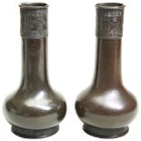 PAIR OF ARCHAISTIC BRONZE VASES 17TH / 18TH CENTURY of bottle form, decorated with stylised bands