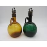 TWO EARLY VICTORIAN FLAGON DECANTERS, CIRCA 1840, hand blown in Bristol Green and amber glass,