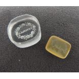 TWO VICTORIAN GLASS INTAGLIO SEALS, CIRCA 1860, the larger clear glass lozenge seal incised with the