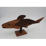 A VINTAGE CARVED SOUVENIR FLYING FISH, CIRCA 1950, carved from Miro wood by inhabitants of