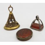 THREE 19TH CENTURY INTAGLIO FOBS, all with incised Carnleian panels, the largest a gilt brass fob