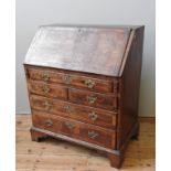 A MID 18TH CENTURY WALNUT BUREAU,  the crossbanded fall front enclosing  a compartmented interior