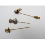 A MARQUISITE 'CROWN' STICK PIN, SEED PEARL AND AGATE STICK PIN AND A REGIMENTAL STICK PIN, all